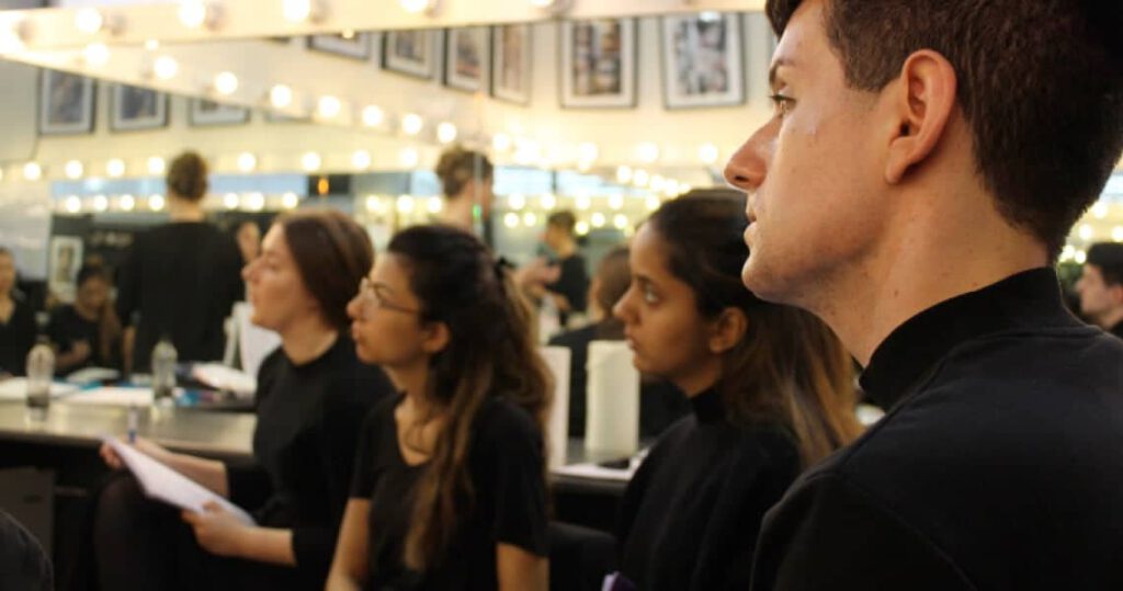 Attentive students of professional beauty course listen to a lecturer